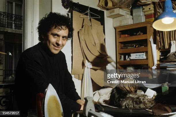Paris in April 1983, the couturier Azzedine Alaia in his studio, with his chubby dog, a Yorkie .