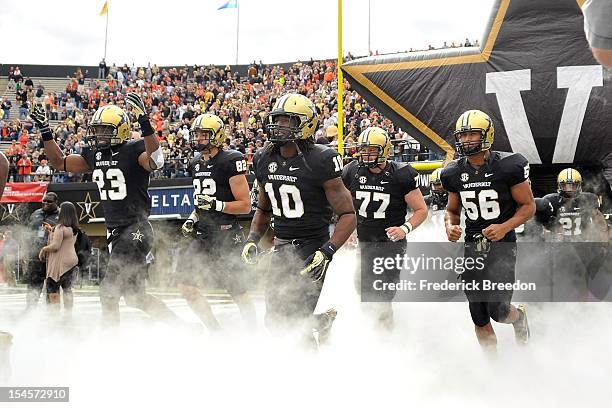 Andre Hal, Kris Kentera, Cory Batey, Spencer Pulley, and Darien Bryant of the Vanderbilt Commodores run out onto the field prior to a game against...