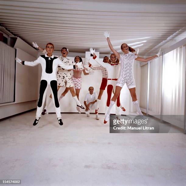 Andre smiling attitude of crouching behind his models COURREGES leaping into the air, dressed in the designer's new creations.