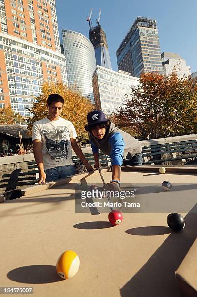 Borough of Manhattan Community College students play pool in Lower Manhattan as One World Trade Center rises under construction on October 22, 2012...
