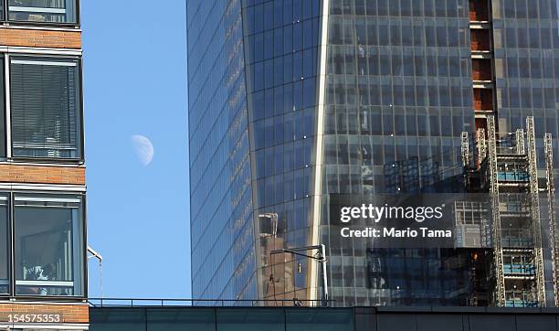 Man is seen in a window in Lower Manhattan as One World Trade Center rises under construction on October 22, 2012 in New York City. The Census Bureau...