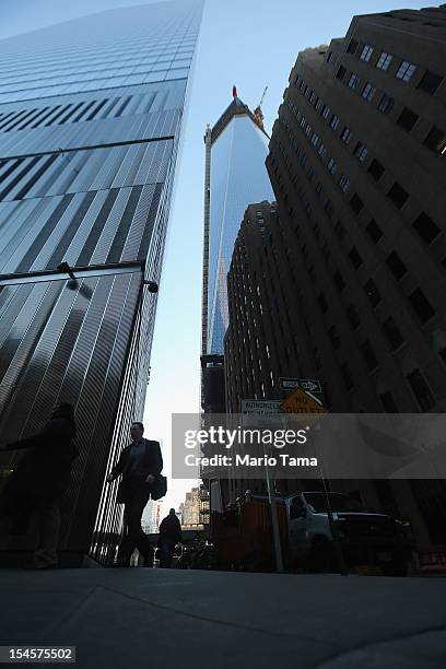 People walk in Lower Manhattan as One World Trade Center rises under construction on October 22, 2012 in New York City. The Census Bureau reported...