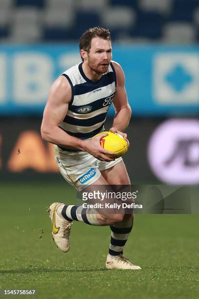 Patrick Dangerfield of the Cats runs with the ball during the round 18 AFL match between Geelong Cats and Essendon Bombers at GMHBA Stadium, on July...