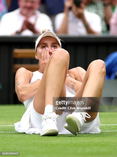 Marketa Vondrousova of Czech Republic falls to the floor as she celebrates winning match point in the Women's Singles Final against Ons Jabeur of...