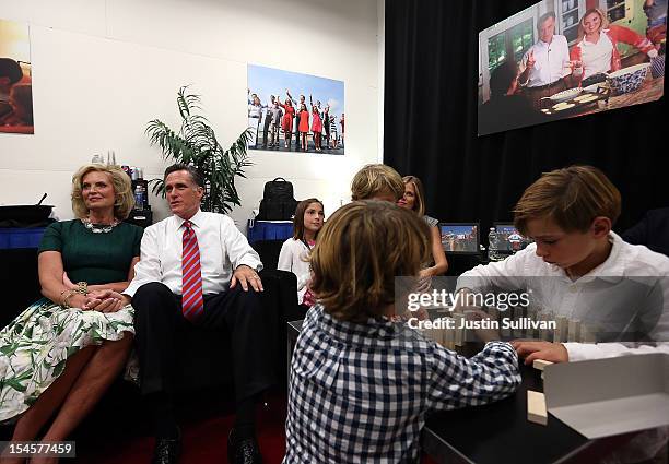 Republican presidential candidate Mitt Romney and his wife Ann Romney sit backstage with members of their family before the start of a debate with...