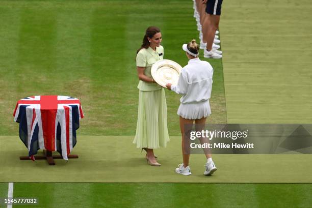Marketa Vondrousova of Czech Republic is presented with the Women's Singles Trophy by Catherine, Princess of Wales following victory in the Women's...