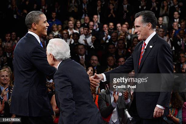 President Barack Obama greets Republican presidential candidate Mitt Romney as moderator Bob Schieffer of CBS looks on prior to their debate at the...