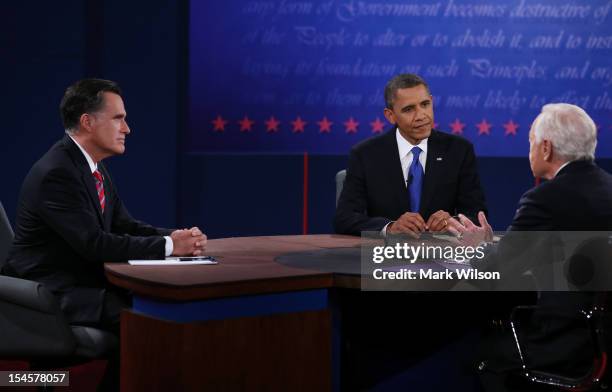 President Barack Obama and Republican presidential candidate Mitt Romney listen as moderator Bob Schieffer of CBS speaks at the Keith C. And Elaine...