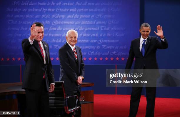 President Barack Obama waves on stage with Republican presidential candidate Mitt Romney and moderator Bob Schieffer of CBS at the Keith C. And...