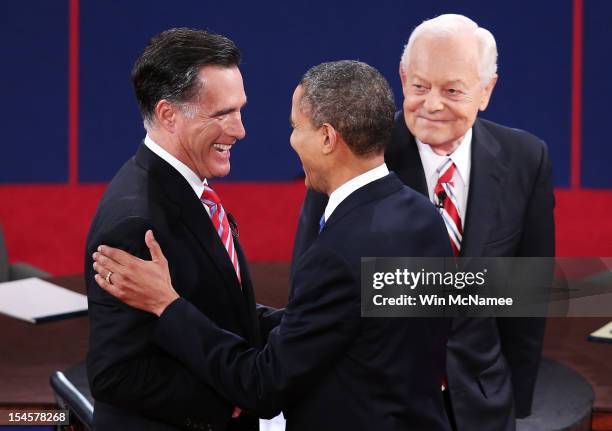 President Barack Obama shakes hands with Republican presidential candidate Mitt Romney as moderator Bob Schieffer of CBS looks on at the Keith C. And...