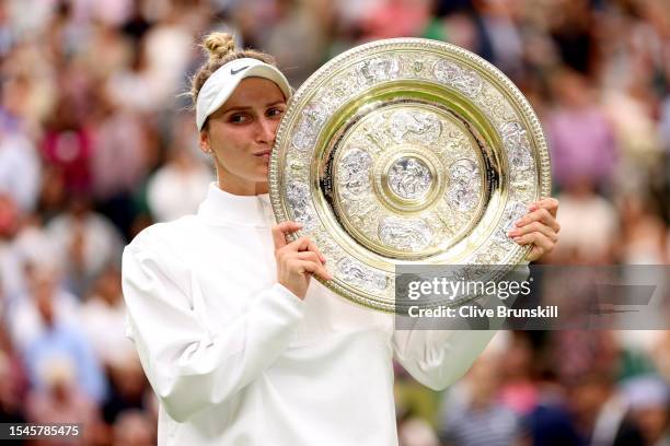 Marketa Vondrousova of Czech Republic kisses the Women's Singles Trophy as she celebrates victory following the Women's Singles Final against Ons...