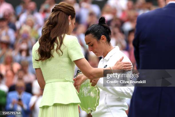 Ons Jabeur of Tunisia looks dejected as she is consoled by Catherine, Princess of Wales following defeat in the Women's Singles Final against Marketa...