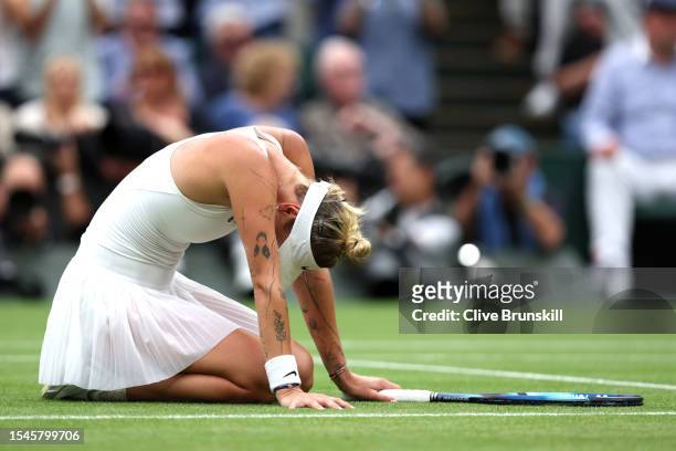 Marketa Vondrousova of Czech Republic falls to the floor as she celebrates winning match point in the Women's Singles Final against Ons Jabeur of...