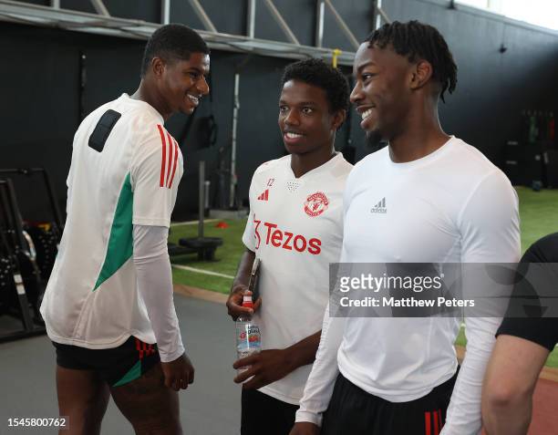 Marcus Rashford, Tyrell Malacia, Anthony Elanga of Manchester United arrives ahead of a pre-season training session at Carrington Training Complex on...