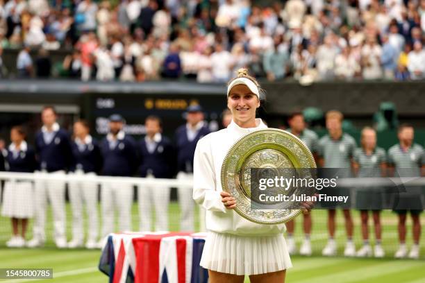 Marketa Vondrousova of Czech Republic smiles with the Women's Singles Trophy following her victory in the Women's Singles Final against Ons Jabeur of...