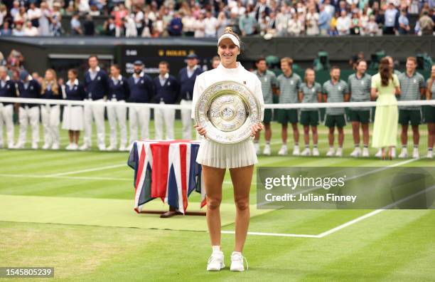 Marketa Vondrousova of Czech Republic smiles with the Women's Singles Trophy following her victory in the Women's Singles Final against Ons Jabeur of...