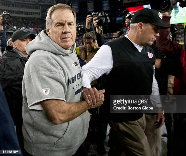 New England Patriots head coach Bill Belichick shakes hands with the New York Jets head coach Rex Ryan after the Patriots defeated the Jets 29-26 at...