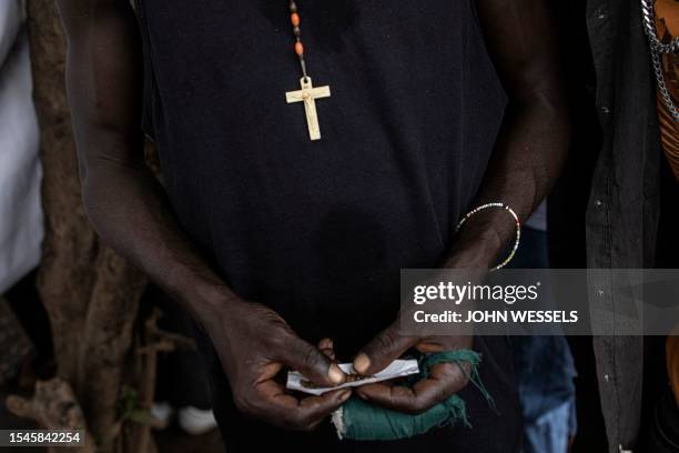 Man rolls his Kush in a drug den in Freetown on June 26, 2023. In recent years Kush, a mix of various chemicals and plants that mimic the natural...