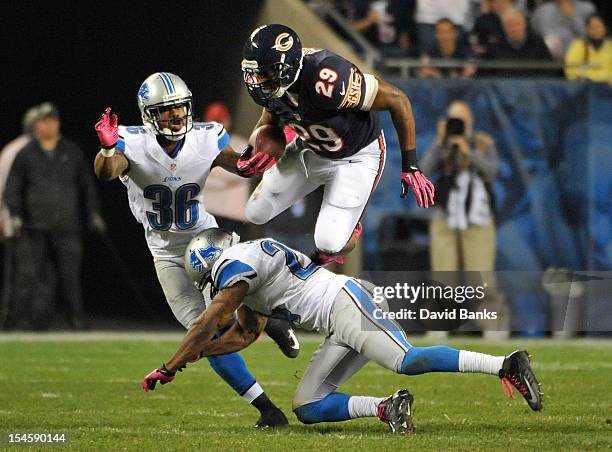 Michael Bush of the Chicago Bears leaps over Erik Coleman of the Detroit Lions on October 22, 2012 at Soldier Field in Chicago, Illinois. The Chicago...