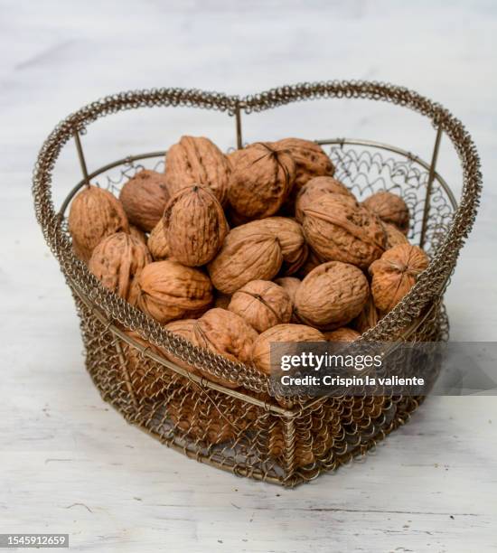 heart-shaped container filled with walnuts - gourmet gift basket stock pictures, royalty-free photos & images