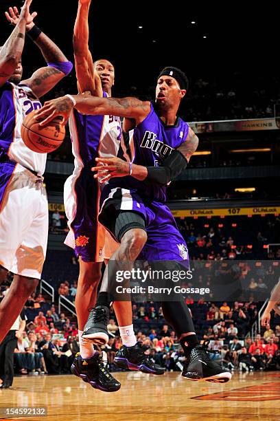 James Johnson of the Sacramento Kings attempts to pass the ball against Wesley Johnson and Jermaine O'Neal of the Phoenix Suns during a pre-season...