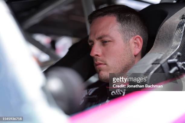 Alex Bowman, driver of the Ally Chevrolet, sits in his car during practice for the NASCAR Cup Series Crayon 301 at New Hampshire Motor Speedway on...