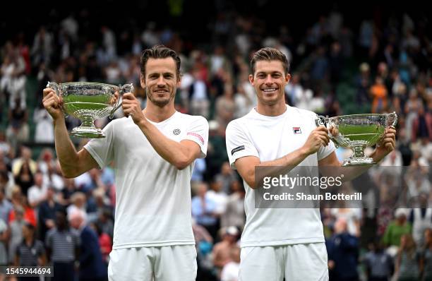 Wesley Koolhof of the Netherlands and Neal Skupski of Great Britain lift the Men's Doubles Trophies following their victory in the Men's Doubles...