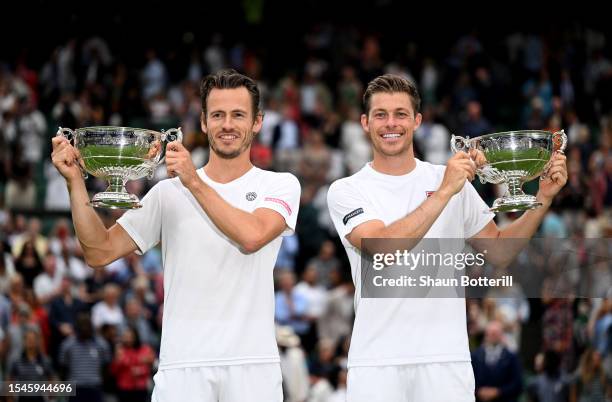 Wesley Koolhof of the Netherlands and Neal Skupski of Great Britain lift the Men's Doubles Trophies following their victory in the Men's Doubles...