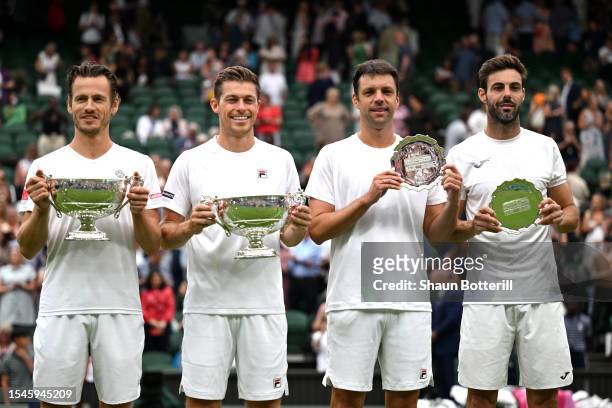 Wesley Koolhof of the Netherlands and Neal Skupski of Great Britain lift the Men's Doubles Trophies with Horacio Zeballos of Argentina and Marcel...