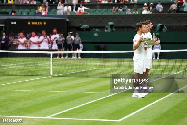 Wesley Koolhof of the Netherlands and Neal Skupski of Great Britain lift the Men's Doubles Trophies with Horacio Zeballos of Argentina and Marcel...