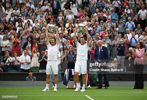 Wesley Koolhof of the Netherlands and Neal Skupski of Great Britain lift the Men's Doubles Trophies following their victory in the Men's Doubles...