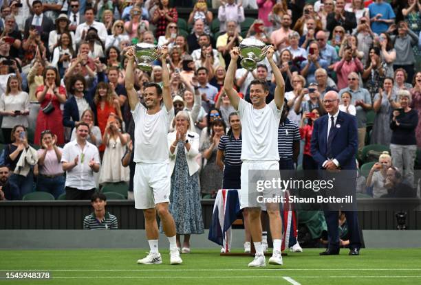 Wesley Koolhof of the Netherlands and Neal Skupski of Great Britain lift the Men's Doubles Trophies following their victory in the Men's Doubles...