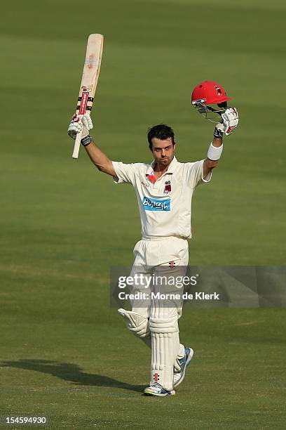 Callum Ferguson of the Redbacks celebrates after reaching 100 runs during day one of the Sheffield Shield match between the South Australian Redbacks...