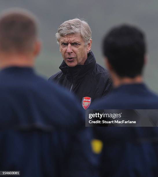 Arsenal manager Arsene Wenger speaks to players during a training session ahead of their UEFA Champions League group stage match against Schalke 04...