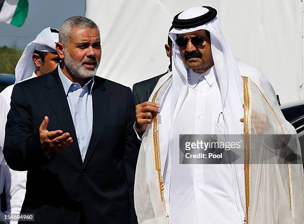 Hamas Prime Minister Ismail Haniyeh of the Palestinian National Authority and the Emir of Qatar Sheikh Hamad bin Khalifa al-Thani arrive to a...