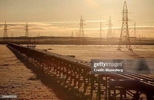 Pipelines stand in front of electricity pylons near OAO Gazprom's new Bovanenkovo deposit, a natural gas field near Bovanenkovskoye on the Yamal...