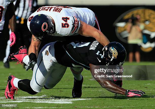 Justin Blackmon of the Jacksonville Jaguars is tackled by Brian Urlacher of the Chicago Bears during the game at EverBank Field on October 7, 2012 in...