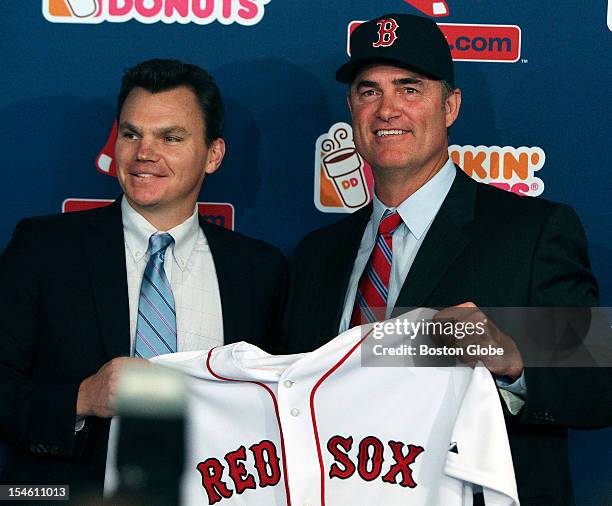 The Boston Red Sox introduced new manager John Farrell, right, at a noon press conference at Fenway Park. Here he poses with general manager Ben...