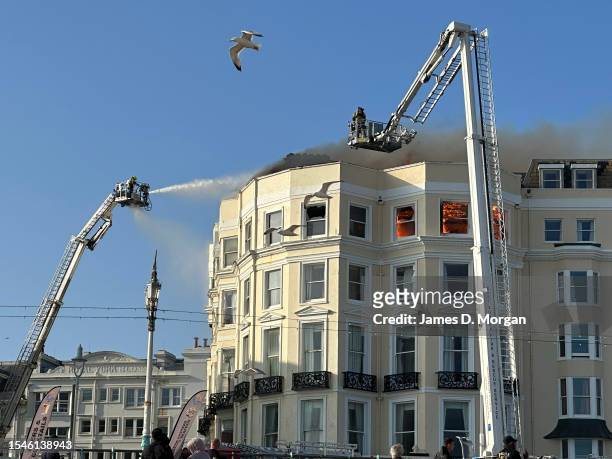 Firefighters on scene at a large fire at the Royal Albion Hotel beside Brighton seafront on July 15, 2023 in Brighton, England. Dozens of fire...