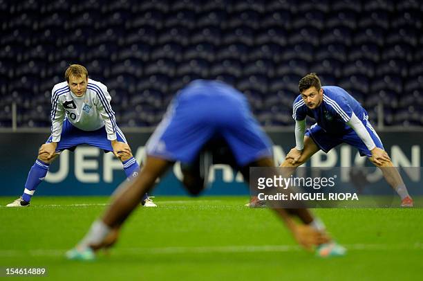 Dynamo Kiev's Oleh Gusev and teammate forward Artem Milevskiy stretch during a training session at the Dragao Stadium in Porto, on October 23 on the...