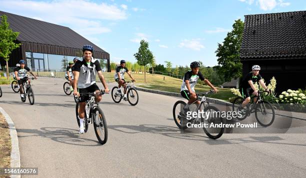 Dominik Szoboszlai, Joe Gomez and Melkamu Frauendorf of Liverpool riding a bike to the training session on July 15, 2023 in UNSPECIFIED, Germany.