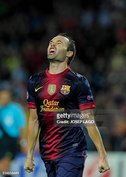 Barcelona's midfielder Andres Iniesta celebrates after scoring during the UEFA Champions League football match FC Barcelona vs Celtic CF on October...