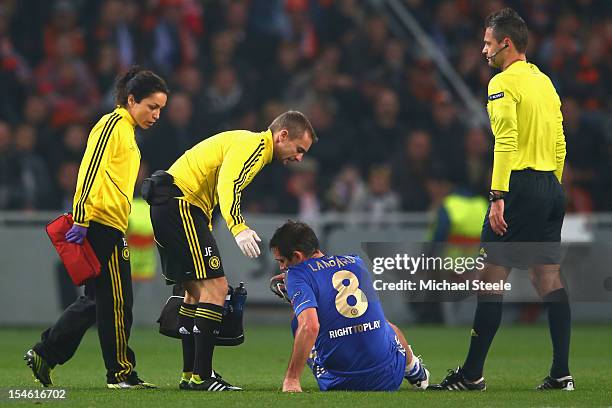 Frank Lampard of Chelsea goes down injured and is substituted during the UEFA Champions League Group E match between Shakhtar Donetsk and Chelsea at...