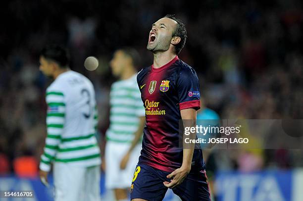 Barcelona's midfielder Andres Iniesta celebrates after scoring during the UEFA Champions League football match FC Barcelona vs Celtic CF on October...