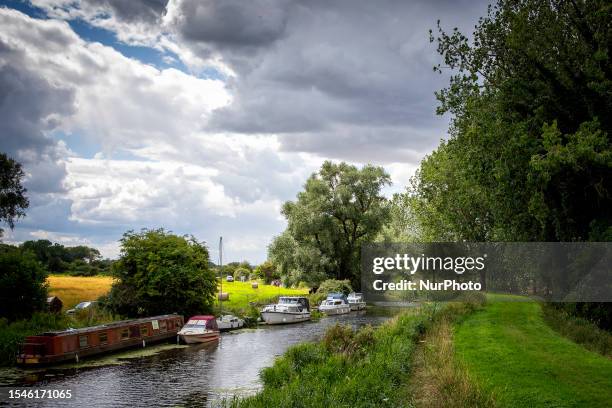 General view of barges and boats on the River Great Ouse near Southery, Cambridgeshire in England on Monday 17th July 2023