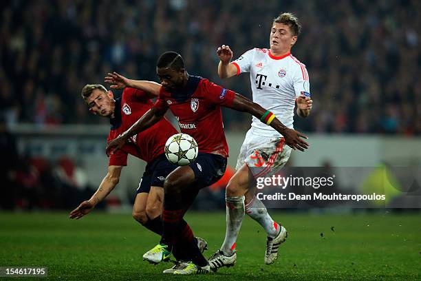 Lucas Digne and Aurelien Chedjou of Lille battle for the ball with Toni Kroos of Bayern Munich during the Group F UEFA Champions League match between...