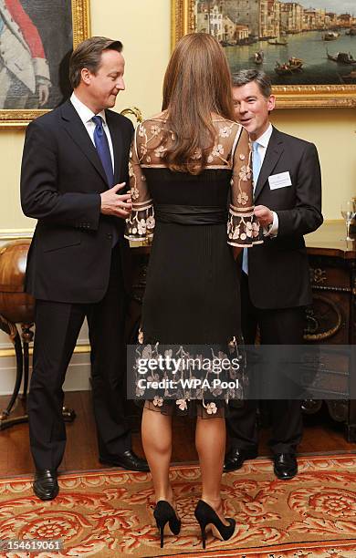 Catherine, Duchess of Cambridge talks with British prime minister David Cameron and British sports minister Hugh Robertson during a reception held...