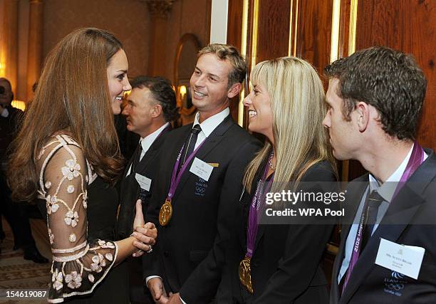 Catherine, Duchess of Cambridge smiles as she talks to Carl Hester, Charlotte Dujardin and Scott Brash during a reception held for Team GB Olympic...