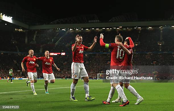 Javier Hernandez of Manchester United celebrates with his team-mates after scoring his team's third goal to make the score 3-2 during the UEFA...