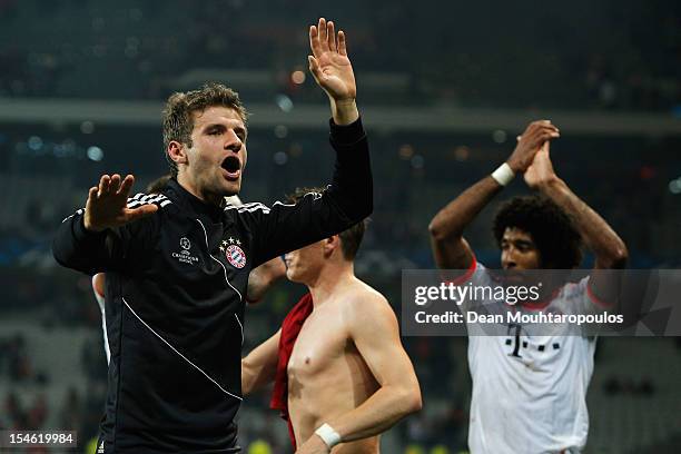 Thomas Muller of Bayern Munich celebrates victory with the fans after the Group F UEFA Champions League match between OSC Lille and FC Bayern...